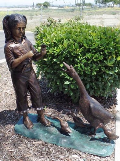 Bronze girl with ducks water feature