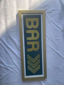 Gold framed bar sign