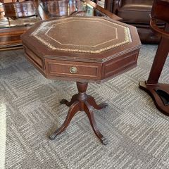 Octagonal occasional table on tripod base with two drawers & brown leather.