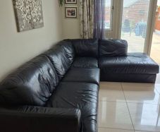 Black leather corner sofa and recliner chair