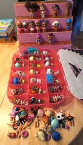 lol bundle, 33 dolls, storage case and display stand.