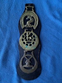 Vintage horse brasses on leather strap