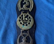 Vintage horse brasses on leather strap