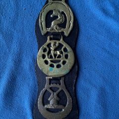 Vintage horse brasses on leather strap