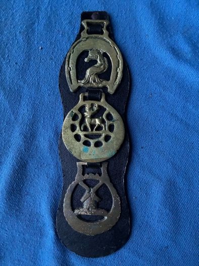 Vintage horse brasses on leather strap