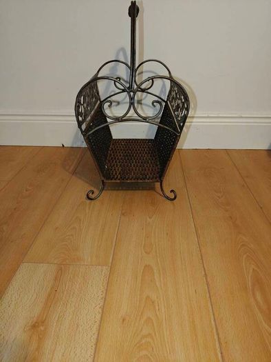 Antique iron and wicker magazine rack. Vintage antique magazine rack.