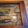 vintage shadow box containing a mix of antique tools, keys, and a loom. Image 10