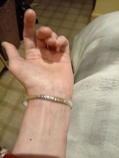Silver tone bracelet with blue stones and words on it