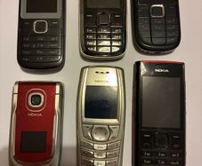 Six vintage Nokia mobile phones.