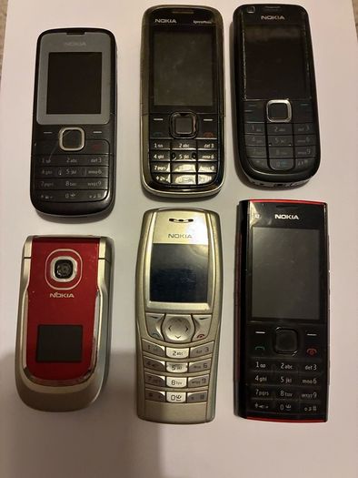 Six vintage Nokia mobile phones.