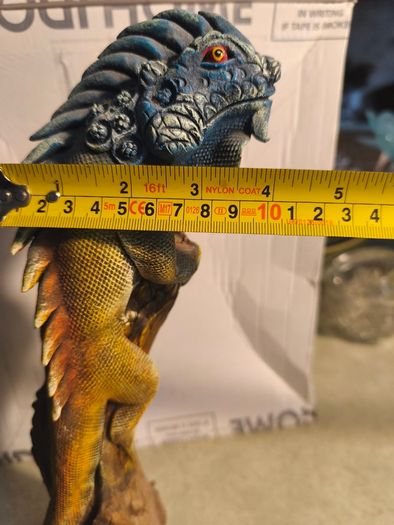 handmade iguana on natural wood log