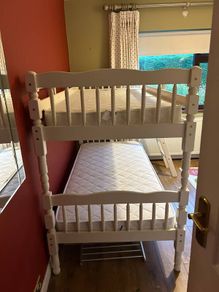 White wooden bunk beds with mattresses