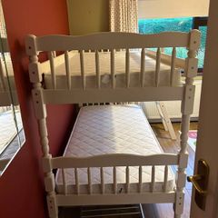 White wooden bunk beds with mattresses
