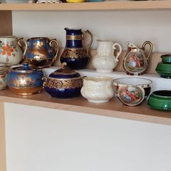Collection of vintage milk pitchers and matching sugar bowls