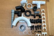 Selection of plastic fittings for plumbing systems on boats.