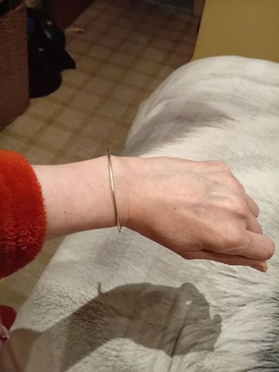 Silver tone adjustable bracelet with charms