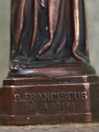 Copper Sacred art statue of Saint Francis of Assisi on marble plinth.