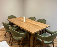 Extendable oak dining table with 6 olive green chairs
