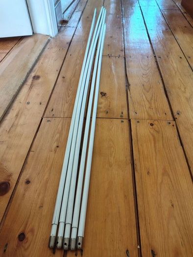 Five white extendable net curtain rods