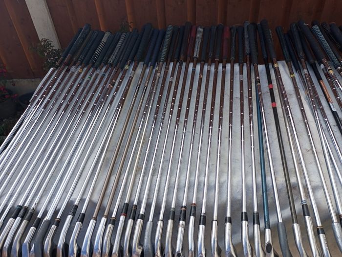 A selection of golf clubs and bags. All right handed clubs.