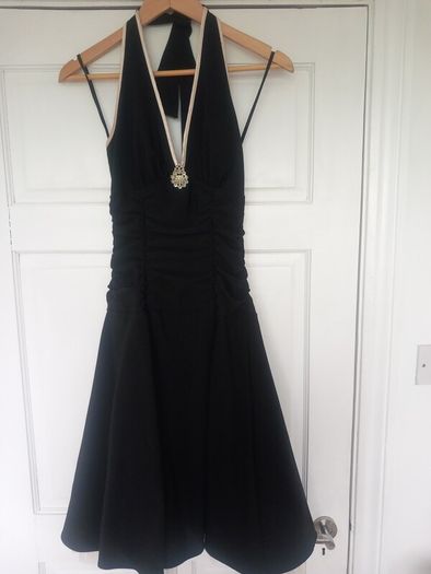 Black halterneck dress with cream trim