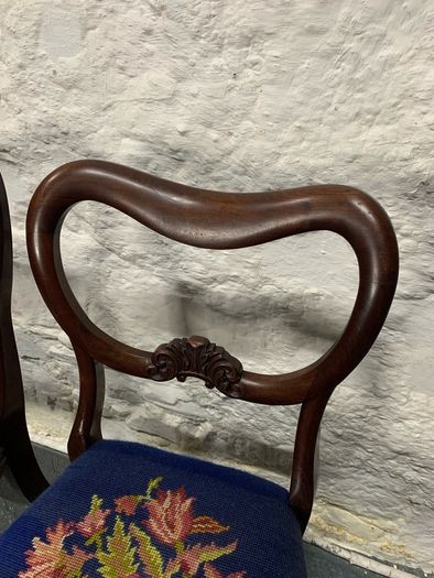 A pair of Victorian mahogany balloon back chairs with tapestry seats.