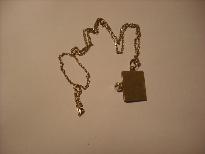 a lovely solid  silver locket and silver chain. in the shape of a book