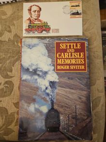 Settle And Carlisle Memories.  By Roger Siviter. 1990 First Edition Large Volume Hardback With Dustjacket In Good Condition.  Plus first day issue stamp.  See Photos For Same.