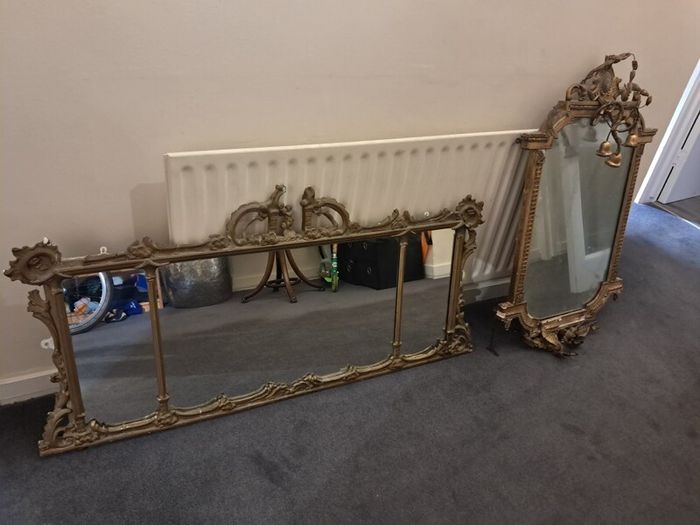 Two distinct antique giltwood mirrors with elaborate French-style ornamentation