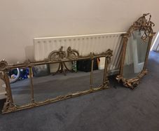 Two distinct antique giltwood mirrors with elaborate French-style ornamentation