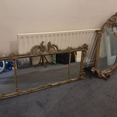 Two distinct antique giltwood mirrors with elaborate French-style ornamentation