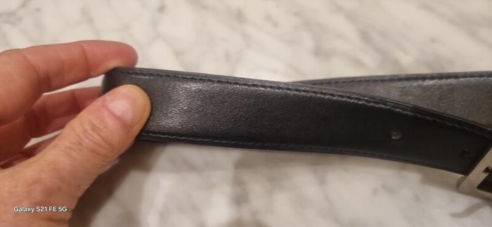 Black leather belt in the style of designer