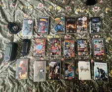 1 PSP console + charger + carry case + 17 games