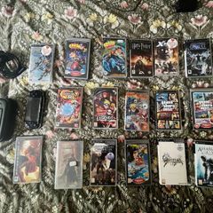 1 PSP console + charger + carry case + 17 games