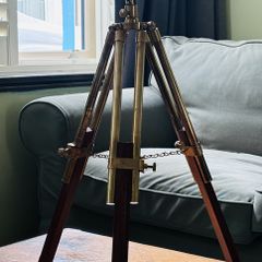 Large brass double barrel binocular telescope on wooden tripod