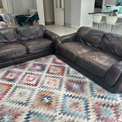 Two Italian leather 3 seater sofas