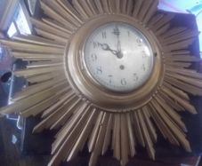 a vintage wooden sunburst clock