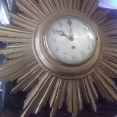 a vintage wooden sunburst clock