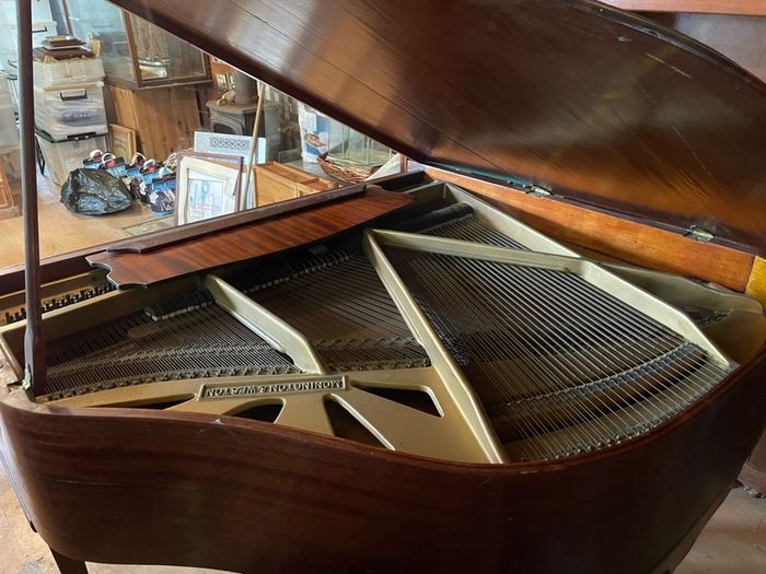 a circa-1931 Monington & Weston baby grand with matching stool.