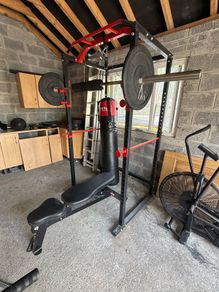 squat rack, bench, barbell and weights