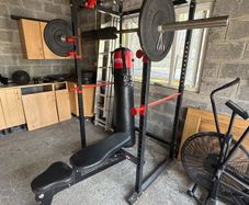 squat rack, bench, barbell and weights