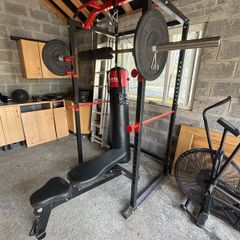 squat rack, bench, barbell and weights