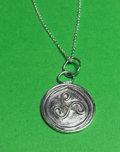 Sterling silver Triskele pendant with 18 inch chain.