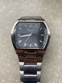 Kenneth Cole designer watch. Water Resistant. A few worn scratches but still working perfectly. Battery easily replaced and sits into the back of it.