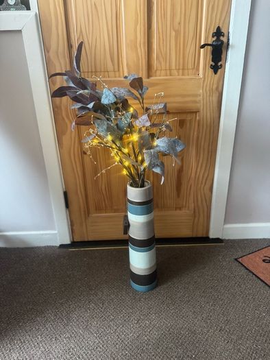 Vase with artificial flowers and lights