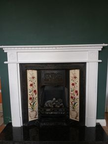 Fireplace in cast iron with wooden surround (painted white) and black marble hearth.   Perfect condition