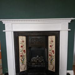 Fireplace in cast iron with wooden surround (painted white) and black marble hearth.   Perfect condition