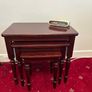 2 sets of nest of tables, one round grooved mahogany and one lighter mahogany square. Image 2