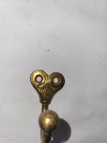 Patient brass coat hangers