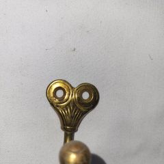 Patient brass coat hangers